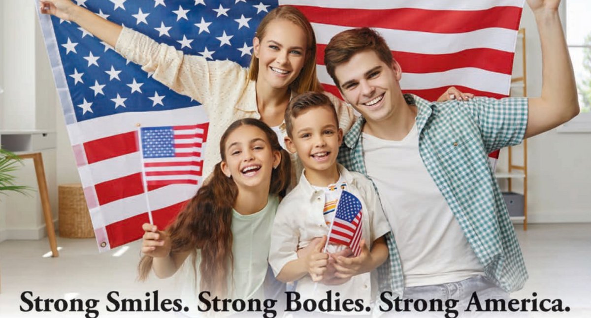 Strong Smiles Family of four posing indoors with American flags, smiling at the camera; banner reads 'Strong Smiles. Strong Bodies. Strong America.'